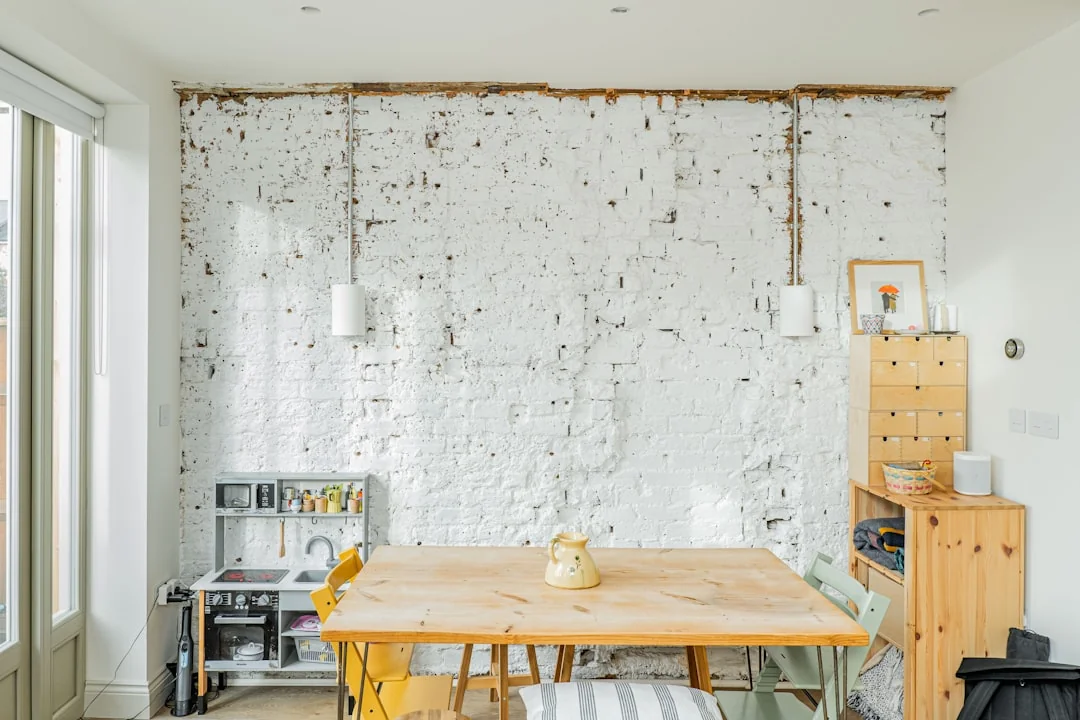 A neat, well-arranged desk with stationery and dusting products for an efficient workspace.